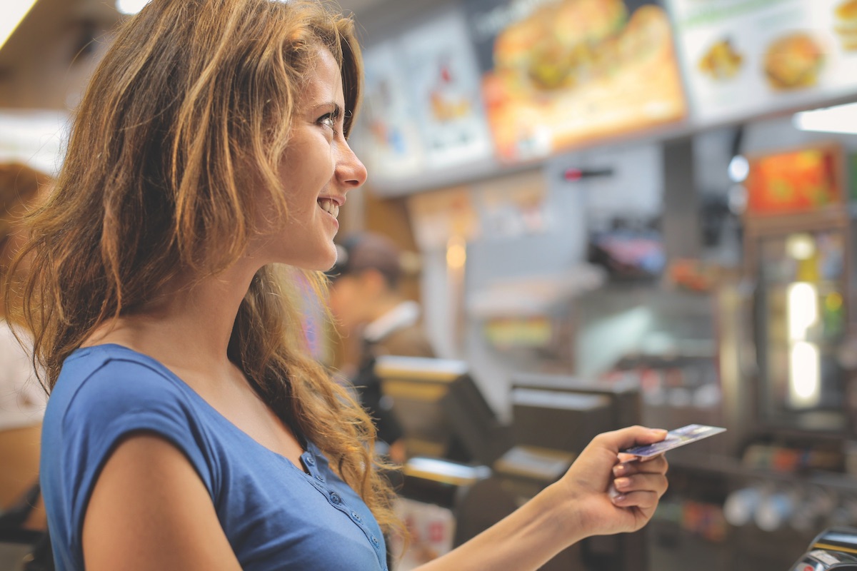 Woman paying with credit card at a fast food restaurant